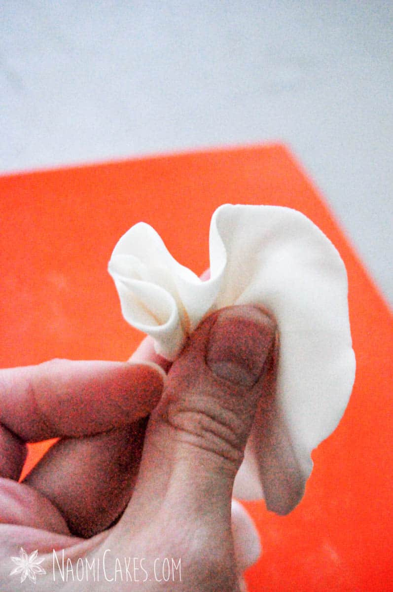 hand holding fondant ruffles for cakes